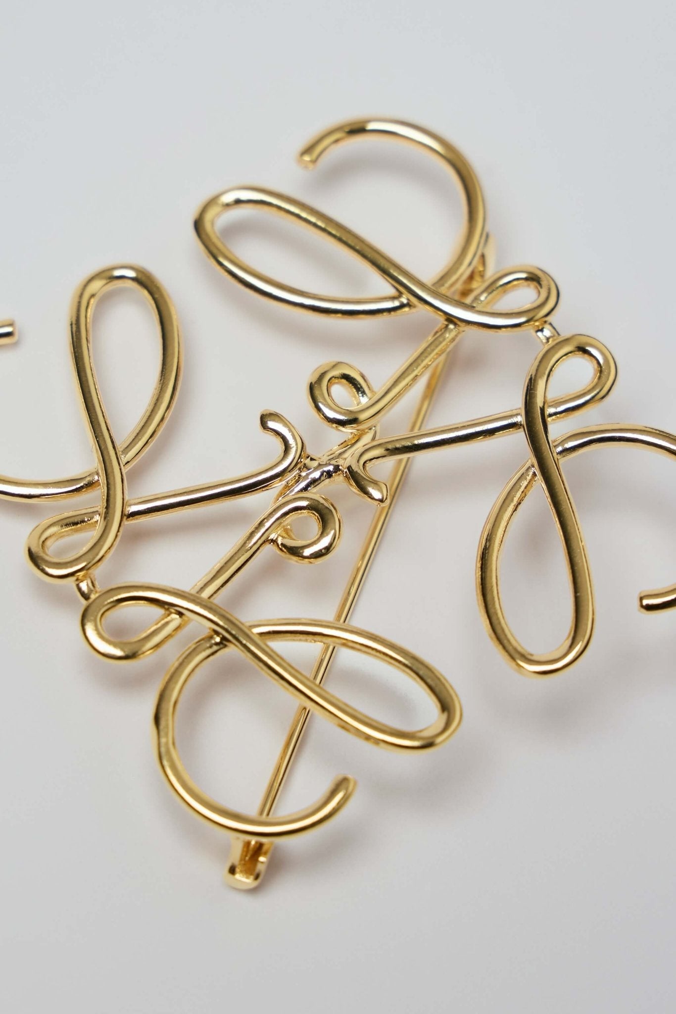 Anagram Brooch in Metal