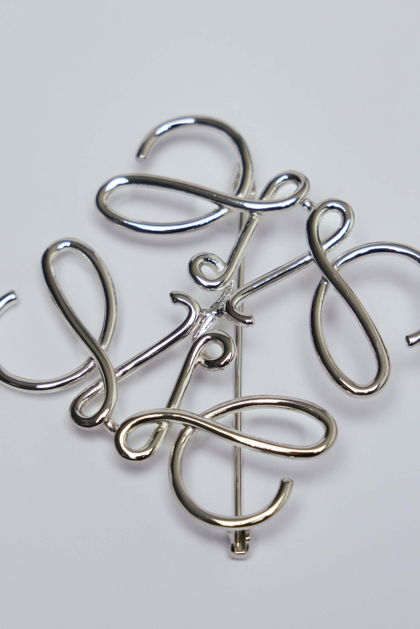 Anagram Brooch in Metal