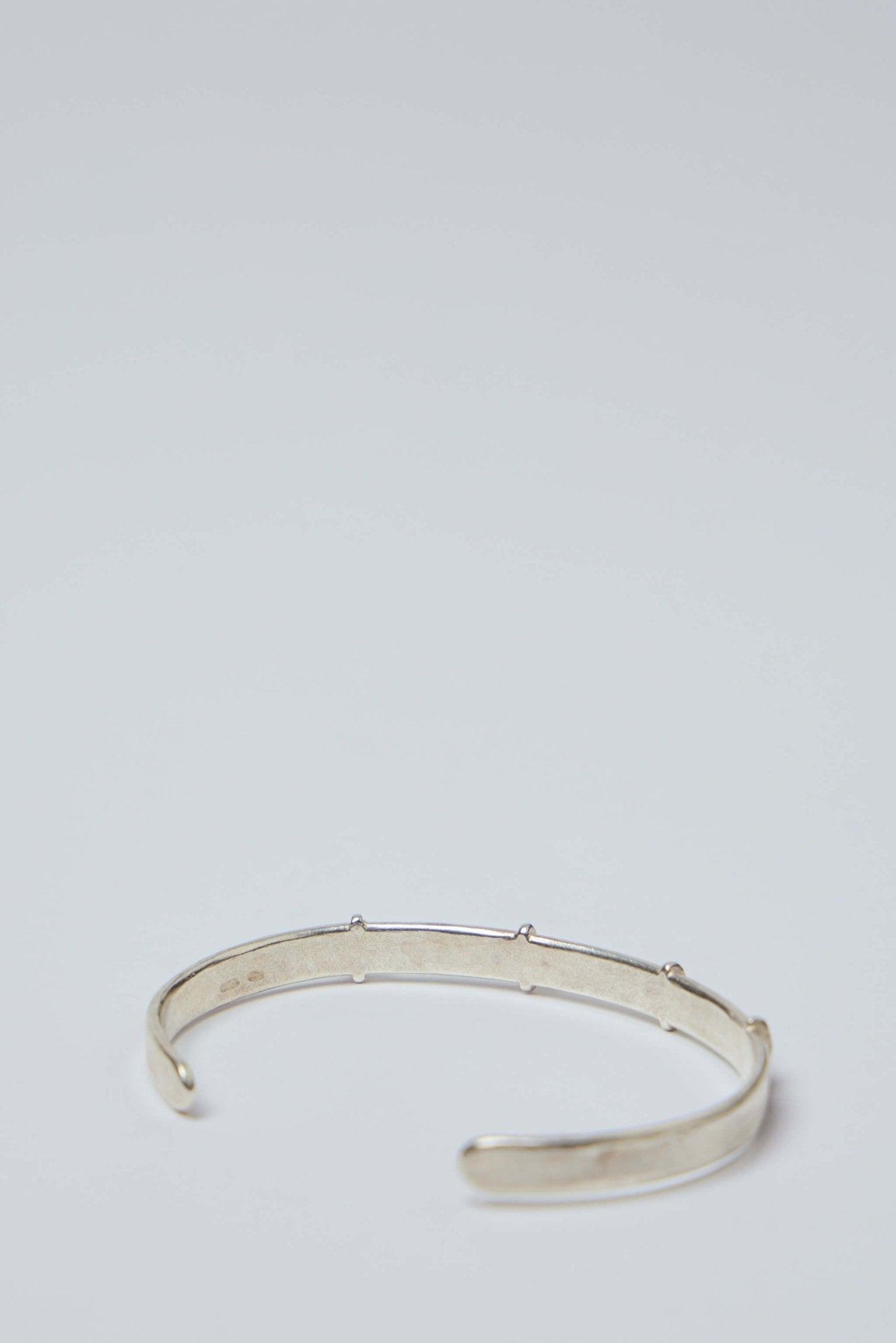 Thin Silver Stitched Cross Bangle
