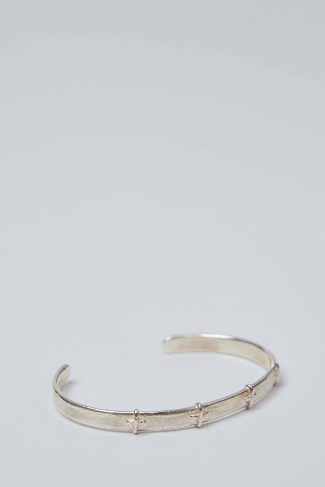 Thin Silver Stitched Cross Bangle
