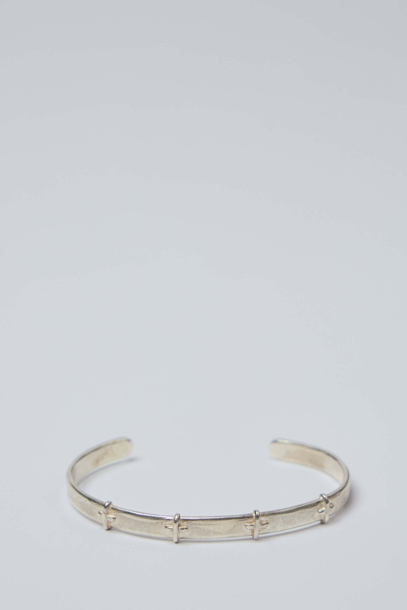 Thin Silver Stitched Cross Bangle